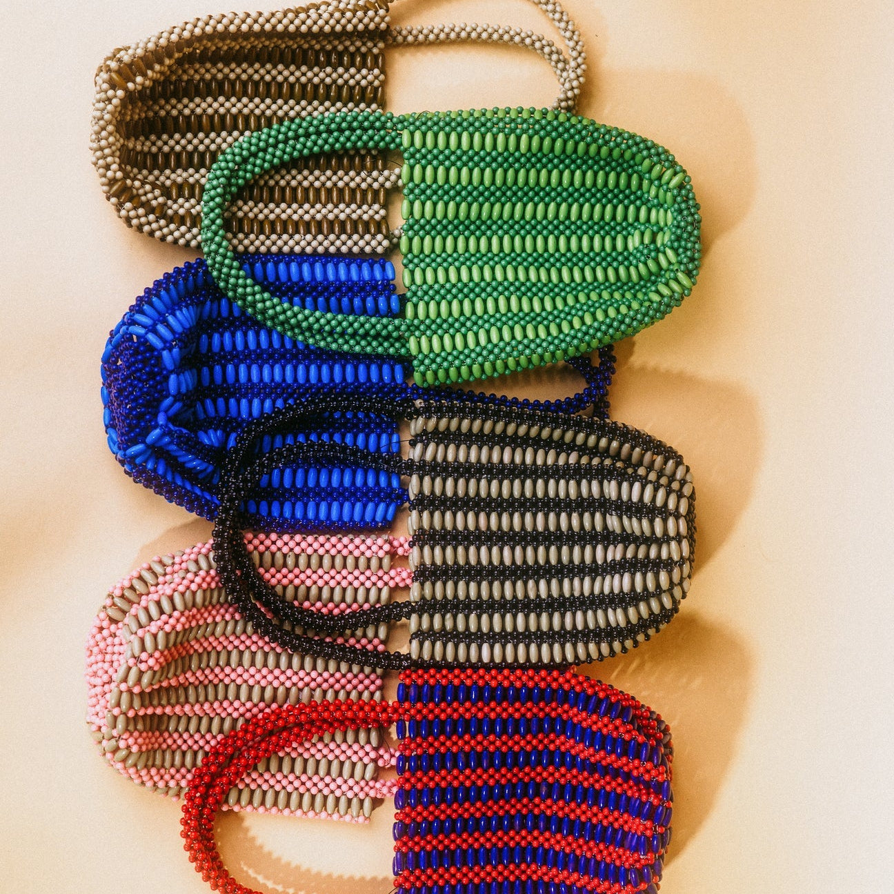 Set of colorful braided keychains on a beige background